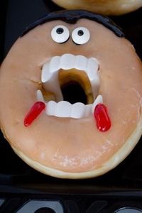 Fight away the monsters by biting into a vampire halloween donut before it bites you! These spooky Halloween themed treats are incredibly easy to make and take hardly any time at all! | halloween donut vampire | vampire donuts halloween treats | halloween donuts with vampire treats | halloween donuts vampire | halloween donuts ideas easy | halloween donuts ideas with teeth