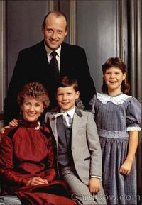 King Harald V of Norway with his lovely family.  Queen Sonja, Crown Prince Haakon, and Princess Martha Louise in front.  King Harald, looking every bit the proud husband and father, standing behind.