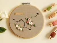 "Floral Science Embroidery Wall Art, Serotonin Molecule Modern Embroidery Hoop Chemistry Gift for Science Lover, Hand Embroidered Home Decor with personalizable felt back. It's perfect for your home decoration, just hang it or lean it. Delightful floral embroidery hoop art, wonderful as a gift to your loved ones on different occasions: anniversary, birthday, Valentine's Day, Christmas, or housewarming. Great as a Chemistry Gift for Science Lover! The neat hand embroidery of this serotonin molecu