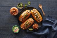 Spice up your BBQ with Vegan Kimchi Dogs! Tofurky hot dogs with Nasoya Kimchi, jalapeno, and cilantro - a tasty twist on a classic favorite.