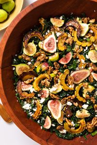 While salads are not traditionally thought of during the fall, this hearty recipe is the epitome of a fall-time salad! It's packed with figs, squash, candied walnuts, and kale and topped with a delicious vinaigrette. | wyseguide.com #fall #salad #squash #figs