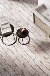 The Levik wood effect tiles feature a chic white finish with heavy distressing for a truly vintage style. These rustic tiles can be applied to both the walls and floor.