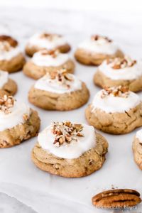 These Maple Pecan Cookies are a chewy maple cookie filled with chopped pecans and topped with a maple cream cheese frosting. | Pecan Maple Cookies with maple cream cheese icing. | Fall cookies recipe with pecans and maple frosting. | Thanksgiving cookie recipe for a fun fall dessert. | Thanksgiving dessert recipe with maple pecan flavor.