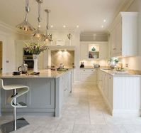 This open plan kitchen is the perfect space for family dining, with feature island and bespoke storage solutions complemented by Miele appliances.