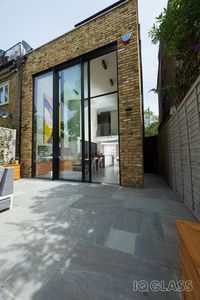 Tall sliding glass doors transforms London property. A conversion of two separate apartments into one family home. The sliding glass doors provide simple access to the outside patio. Click on the link below to see more stunning renovation and refurbishement projects.