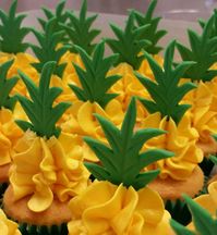 Pineapple mini cupcakes. Pineapple flavoured swiss buttercream with fondant topper. Jan 2017.