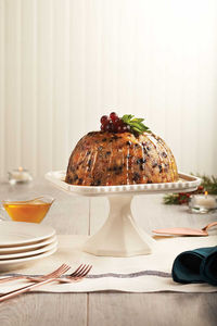 Drizzled with a rich brandy-butter sauce, this traditional Christmas pudding is a luxurious way to cap off a holiday meal.