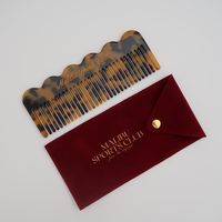 Get ready for a truly unique hair comb experience with our Tortoise Logo Massage Comb! Not only does it untangle and smooths your hair but its curvy design also doubles as a gua sha lymphatic tool. Experience the benefits of improved circulation and tangle free hair in a single crafted comb Details: 100% acetate Laser engraved logo Smooth rounded edges Comes with logo velvet pouch