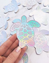 "TURTLE STICKER for Car, Laptop, Water Bottle Sticker (in WHITE rainbow holographic): ⋒ Use this rainbow holographic vinyl sticker on your laptop, tablet, notebook, water bottle, phone, journal, mirror, car window, bumper, etc. ⋒ Created & shipped from our art studio in Kaneohe, Hawaii.🌈 ⋒ Waterproof, die-cut vinyl sticker of our original turtle design Sticker Size (inches): 3.5\" x 3.25\" (8.9cm x 8.26cm) Choose your Sticker Quantity in the dropdown menu! Our stickers are made from a durable v