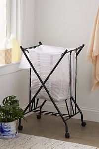 Make laundry day a breeze with this bounce-back laundry hamper equipped with a bungee bag that pushes your garments to the top. Complete with castors and wheels (included) so you can easily transport your hamper from room to room. Content + Care Assembly required - instructions and hardware included Steel, fabric Wipe clean Imported Size Dimensions: 18.25" l x 20.5" w x 33" h Bag dimensions: 14" l x 16" w x 22.5" h Weight: 3.97 lbs Shipping package dimensions: 8" l x 3" w x 37.5" h Shipping package weight: 4.85 lbs | Single Bounce-Back Laundry Hamper in Black/White at Urban Outfitters