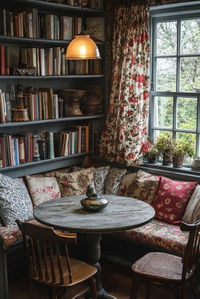 Cozy Cottage Dining Corner in a shabby chic dining room features snug seating arrangements, such as a built-in bench with plenty of cushions and a round table for easy conversation. Floral curtains and tablecloths bring a burst of cheerfulness to the space, while a small, hand-painted sideboard adds functional charm. This corner is designed for intimate family meals or coffee with friends, offering a warm and inviting atmosphere. Discover more cozy cottage dining corner designs by clicking here.