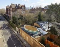 This #newbuildhouse in London was hidden from the street by building it behind the existing street wall. A pop up section of roof was filled in with #framelesswindows to bring light into the #smallhousedesign. A small #glazedcourtyard to the rear also provided light.