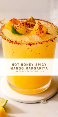 This Hot Honey Spicy Mango Margarita is the perfect summer drink. It's made with hot honey which adds the perfect amonut of heat to the sweet fresh mango puree that you'll shake with tequila, orange liqueur and lime juice. Pour this over ice in a glass rimmed with chili lime seasoning and you've got yourself the most perfect hot summer day cocktail!