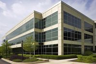 A modern office building with a blue sky in the background, USA. Corporate office building exterior,