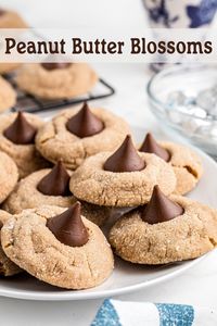 Get a classic, easy recipe for peanut butter blossoms! These soft, chewy cookies topped with a chocolate kiss are a holiday favorite you can enjoy all year.