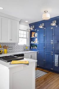 Fresh Traditional kitchen with blue and white cabinetry and an icebox inspired pantry storage area. Perfect for entertaining and cooking efficientally in a small space.