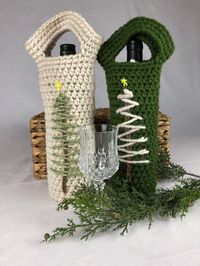 Hand crocheted, Christmas tree embellished wine or bottle gift bag  - perfect for hostess gifts, holiday parties,  appreciation gifts.  Any standard 750 ml wine/liquor bottle will fit.  Also great for carrying water bottles.  Use them to stuff gifts in too! This bag is offered in either an aran (natural) or spinach color scheme and is embellished with a rustic evergreen tree design. These re-usable bags eliminate single use paper gift bags and add unique pizzazz when you need to bring a bottle of wine to an event or present it as a gift!   Stock up with a few to keep on hand for that unexpected need and to take advantage of my free shipping offer! You can find more here =>  https://www.etsy.com/your/shops/PrettyYarnThingsPYT/tools/listings/section:30954185,order:ascending Machine wash/line