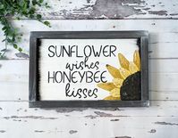 "Add a little farmhouse style to your home with this adorable hand painted \"Sunflower Wishes, Honey Bee Kisses\" framed sign. The sunflower is hand painted with a palette knife to give dimension and texture! The back ground is white and the frame is a brown. *Due to being hand painted, the details of the sunflower may vary from the listing picture.* This is PERFECT to add to your home decor or would make a wonderful gift. This framed sign would look beautiful hanging on your wall, or on your ma