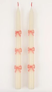 These tapered bow candles, have a special surprise detail - pink wicks! A wonderful hostess gift, or use to decorate the table or mantel at a party where pink will look just perfect, like a baby shower, bridal shower, princess or fairy party. DETAILS: Dimensions: 11" H Embossed and hand painted pink wax bows Ivory candles Tapered shape Pink wicks Burn time is 5 hours Presented in a cream box Fragrance free Pack of 2