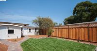 exterior of garage (l) + separate studio (r). View from front door of house. Rear wall of studio is directly on street-side property line. No windows facing sidewalk.