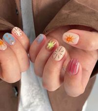 These nails feature a playful summer design with soft pastel blue, peach, and nude tones. The intricate sun and abstract patterns evoke the carefree spirit of sunny days.  🌸Click on the image to shop our Korean Gel Nail Polish Collection  🌸Credit: sy__nail_ on Instagram 🌸summer nail designs, pastel nails, sun nail art, Korean gel polish, abstract nail design, trendy summer nails, cute nail art, bright nail colors, summer manicure, Instagram nails