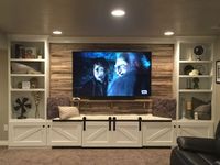 Our hand crafted entertainment center built in with 75 yr old reclaimed  wood behind our Tv