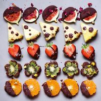 simple chocolate dipped fruit. healthy vegan snack. with strawberry, fig, pineapple, kiwi and orange