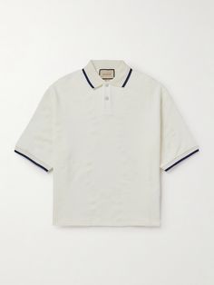 Gucci's polo has been made in Italy from substantial loopback cotton-jersey, so it feels more like a lightweight sweatshirt. Detailed with contrast tipping, it's flocked with its 'Double G' motif and cut with exaggerated side slits for a comfortable fit through the hem. Wear yours with the matching shorts and the label's signature loafers. Designer Cotton Tops With Striped Collar, Casual Gucci Cotton Polo Shirt, Gucci Cotton Polo Shirt, Classic Gucci Cotton Polo Shirt, Casual Gucci Polo Shirt, Casual Gucci Collared Polo Shirt, Gucci Casual Collared Polo Shirt, Gucci Classic Cotton Polo Shirt, Designer Cotton Tops With Ribbed Collar