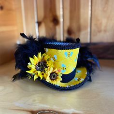 Top off your bee themed mannequin, wreath or shop display with this amazing Bumblebee Mini Top Hat! This little beauty is made of a sturdy yet flexible CVA foam base, covered with coordinating fabrics and trim. The sunflower embellishment and black feathers finish off the hat in style. This is made to order so please allow time for creating and shipping. The sunflowers may vary slightly depending on availability but be assured that they will be of equal or greater quality. Please note in comments if you would like elastic attached and if so state your preference of black or white. Sunflower Festival, Bee Costume, Mini Top Hat, Afternoon Tea Parties, Beautiful Horse, Mini Top, The Sunflower, Tea Parties, Bee Theme