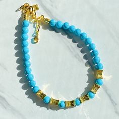 Our Antigua Turquoise Beaded necklace is a breath of fresh air, with brilliant blue hues that are reminiscent of the waters in Antigua. We're now offering in matte gold as well as shiny gold. Etched gold beads offer a striking contrast and we've added some chain so you can adjust the length. Necklace measures 18” in length with lobster clasp closure and is free from cadmium, lead, and nickel. Please note every batch of turquoise varies in color. The Wonder, Turquoise Beaded Necklace, Gold Beaded Necklace, Turquoise And Gold, Turquoise Bead Necklaces, Semi Precious Gems, Diamond Choker, Length Necklace, Gold Bead Necklace