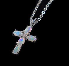 The Cross Opal Necklace features five oval shaped opals to form a cross with a cubic zirconia centre. It is set in high quality 925 sterling silver. It comes with a complimentary metal chain. The opals are sourced from Coober Pedy, South Australia. Australia has 95% of the world's supply of commercial opal and the largest percentage still comes from the 70 opal fields around Coober Pedy. Opal height and width:  5 x 4 mm (individual opal) Pendant height and width: 24 x 13 mm Necklace length: 450mm Due to the inherent uniqueness of opals, the image may differ from the item you receive. If you have a specific colour preference, please note it upon checkout or enquire prior to purchase and we will try to accommodate this as best as possible. At Opalstore Australia we pride ourselves in providi Coober Pedy, Cross Jewelry, Cinnamon Roll, South Australia, Opal Pendants, Opal Necklace, Blue Opal, Star Necklace, The Cross