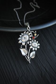 ITEM DESCRIPTION: The size H 3 cm x W 5 cm Weight - 5 g. You can buy it with a silver chain or without it. I made this Sunflower pendant of sterling silver 925, garnet, and citrine. I used these warm stones to make this summer charm brighter and more joyful. These amazing flowers are full of vitality and energy. This is a piece of really modern and detailed jewelry. This handmade necklace will come to you in a gift box - ready for gifting. The parcel will be sent during 1-2 days after payment. D Sterling Silver Nature-inspired Necklace For Anniversary, Nature-inspired Sterling Silver Necklace For Anniversary, Amber Sterling Silver Round Pendant Jewelry, Sterling Silver Jewelry With Oxidized Finish For Gift, Oxidized Sterling Silver Jewelry For Gift, Sterling Silver Jewelry With Oxidized Finish As A Gift, Sterling Silver Hallmarked Pendant Necklace, Spiritual Oxidized Flower Pendant Jewelry, Flower Pendant Necklace With Oxidized Finish For Gift