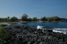 a rocky beach with waves coming in from the ocean