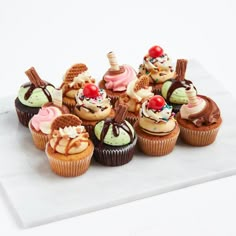 there are many cupcakes with different toppings on them