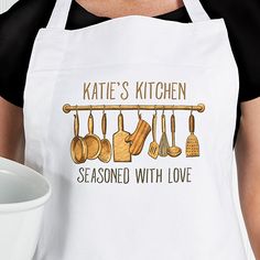 a woman wearing an apron with cooking utensils on it