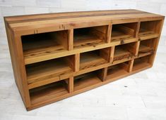 a wooden shelf with several compartments on it