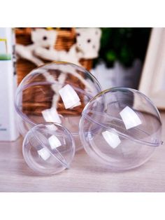 two clear plastic balls sitting on top of a table