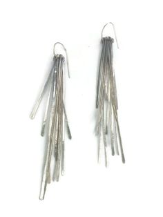 "A sleek pair of sterling silver earrings to ring in the New Year. Hand forged fringe have a shimmery and kinetic quality. The light catches the fringe in a lovely way. They are Oxidised and brushed to a dark shiny finish. The earrings are 4\" long x 1/2\"" Silver Fringe Drop Earrings, Contemporary Silver Earrings For Evening, Contemporary Silver Evening Earrings, Silver Fringe Metal Earrings, Silver Fringe Long Drop Earrings, Silver Long Drop Linear Earrings For Evening, Silver Long Drop Earrings For Evening, Modern Silver Linear Earrings For Party, Dark Silver Earrings