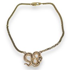 Embrace bold sophistication with the Python Necklace, a striking piece designed to capture attention. This gold-filled snake necklace features an intricately detailed coiled serpent pendant, symbolizing power and transformation. Set on a sturdy yet elegant chain, the serpent pendant boasts a polished finish, making it the perfect statement piece for any occasion. Lightweight and versatile, this snake necklace seamlessly elevates your style, whether for a night out or everyday wear. The timeless design and luxurious gold tones make this necklace an essential addition to your jewelry collection. Exposure to the salt from sweat can cause your pieces to become dull. Be mindful that perfume, hairspray and hand lotions may tarnish your gold filled jewelry due to the harsh chemicals they contain. Halo Jewelry, Gold C, The Serpent, Crystal Eye, Snake Necklace, Hand Lotion, Watch Necklace, Polish Jewelry, Gold Filled Jewelry