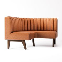 a brown leather couch sitting on top of a wooden frame