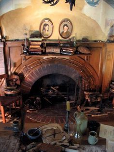 an old fireplace with some pictures on it