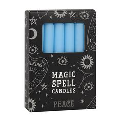 three blue candles in a black box with stars and moon designs on it, set against a white background