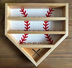 two baseballs are in a wooden box on the table