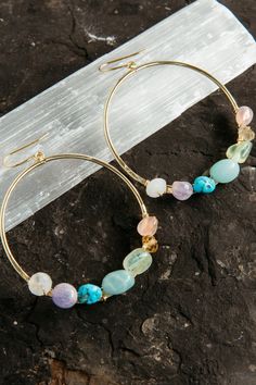 "Wear these 7 chakra energy hoops to balance and harmonize all your chakras. Handmade using 7 unique earth stones, these earrings are so gorgeous. It's like you're taking a piece of the rainbow with you wherever you go.  ▲ 2\" hammered gold plated hoops  ▲ 7 gemstones: raw opal, amethyst, citrine, chrysoprase, larimar, coral & tourmaline ▲ Weight: 1/8 oz  ▲ Handmade in Arizona  Love hoop earrings as much as we do?  Shop them all here!  https://etsy.me/3txKbEn ✦ O R D E R - P R O C E S S I N G - Hoops With Stones, Chip Jewelry, Crystal Jewelry Diy, Raw Crystal Earrings, Wire Jewelry Earrings, Planter Diy, Handmade Hoop Earrings, Chakra Energy, Gemstone Hoop Earrings