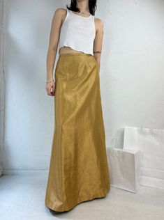 "- Vintage 90s Shawn Alexander poly maxi skirt - 100% polyester - Made in Canada - Zipper up the side - Tagged 6 Waist: 27\" Hip: 19\" Length: 42.5\"" Gold Maxi Skirt, Long Skirt Formal, Maxi Rock, 80s Skirt, Cowichan Sweater, Argyle Cardigan, Gold Skirt, Racer Jacket, Brown Tweed