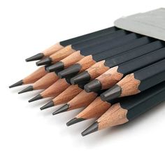 a bunch of pencils that are next to each other with a sharpener on top