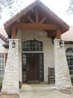 the front entrance to a home with two benches