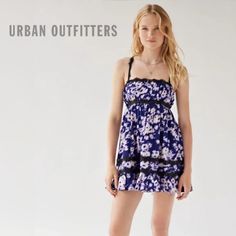 New Without Tag! New Urban Outfitters Eliana Strappy Back Floral Babydoll Dress Size: Large Color: Violet / Purple / Blue / Black / White Feminine And Dainty Babydoll Mini Dress From Urban Outfitters In A Floral Print. Cut With A Straight-Across Neckline, Empire Waist And A Swingy A-Line Mini Skirt Plus A Low-Cut Back With A Lace-Up Detail. Complete With Lace Trim Throughout. Content + Care - 96% Polyester, 4% Spandex - Machine Wash *New Without Tag! Still Has Tag Barb, Never Worn, Perfect Condi Purple Sundress Mini Dress For Summer, Summer Purple Sundress Mini Dress, Purple Cotton Mini Dress For Day Out, Purple Ruffled Mini Dress For Summer, Purple Sundress For Summer, Purple Cotton Mini Dress With Ruffles, Urban Outfitters Cotton Mini Dress With Ruffles, Purple Cotton Dress For Day Out, Purple Ruffled Mini Dress For Beach