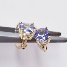 "Thanks for shopping our vintage estate store. We tend to sell well below wholesale and truly hope you enjoy all of our items. Many of the items are one of a kind, so please enjoy scrolling through the pictures and hopefully something will catch your eye. Nice estate 14k yellow gold natural 1ct round 5mm tanzanite lever back studs. These are being custom hand made in our shop. Length: 5/8\" Width: 6mm 1/4\" Weight: 1.20 grams Carat: .50ct per stud Gem: 5mm Nice 14k gold earrings, some that you w Classic Tanzanite Earrings For Anniversary, Classic Round Tanzanite Earrings, Stone Earrings Studs, Beach Rings, Earrings Studs, Natural Tanzanite, Diamond Rings Bands, Diamond Eternity, Cz Diamond