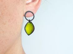 Leaf earrings in oxidized silver and lime green enamel. Measurements: 35mm long and 15mm width. Closure: push back. These contemporary earrings are handcrafted and unique piece. These enamel earrings belong to the Pètals collection. Very light and comfortable to wear. They will be perfect for everyday. The design of these earrings is inspired by the color and beauty of a flower. Choose the enamel color that you like the most. I can also make them in white matt silver. Customize them as you like Green Enamel Single Earring, Single Green Enamel Earring, Green Oxidized Drop Earrings, Green Oxidized Finish Earrings For Gift, Green Sterling Silver Earrings With Oxidized Finish, Modern Silver Earrings, Oxidized Silver Earrings, Contemporary Earrings, Yellow Earrings